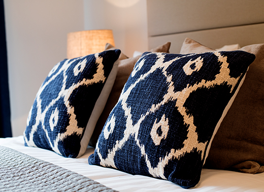 Photo of two cushions on a bed