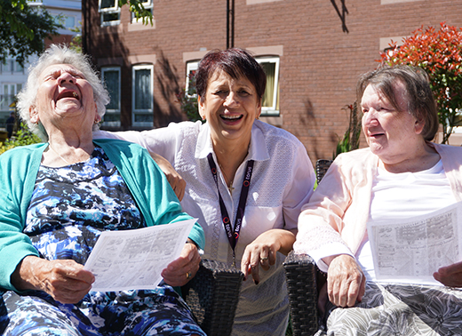 Photo of three people laughing