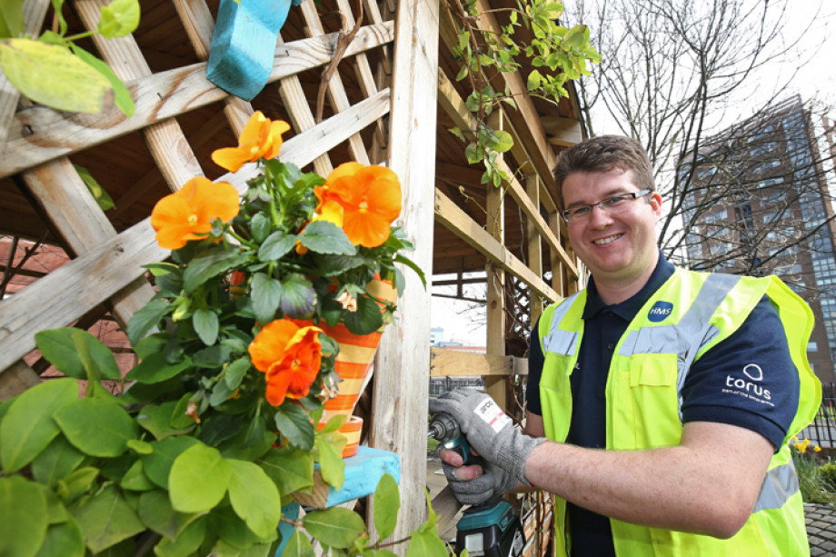 Photo showing someone using a drill on a trellis