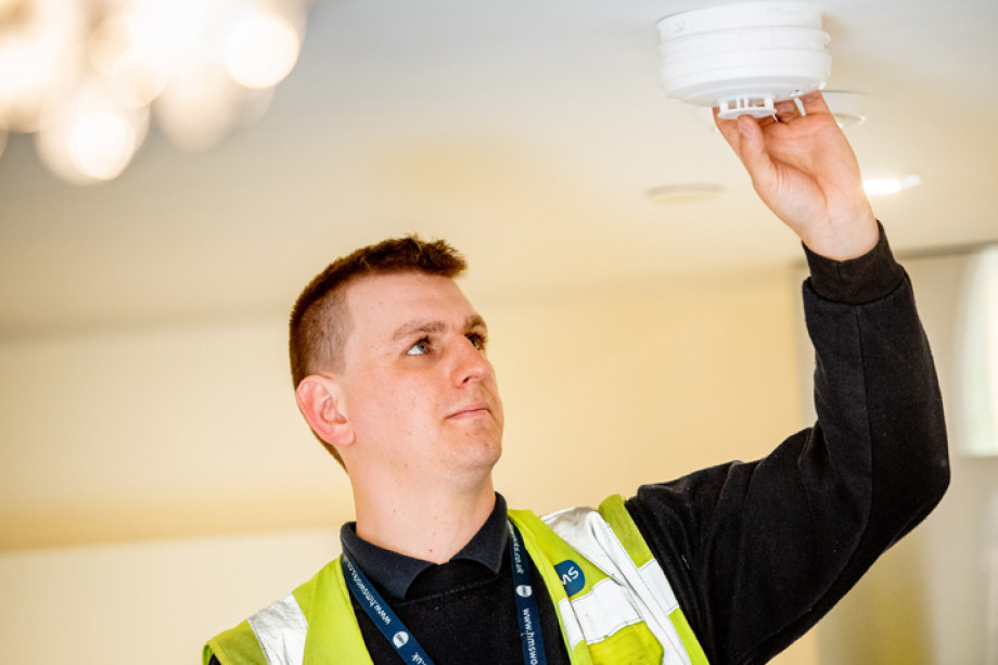 Photo of someone replacing a smoke alarm