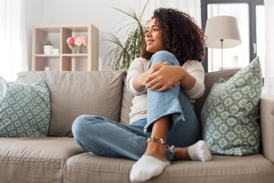 Photo of someone sitting on a sofa with their legs up