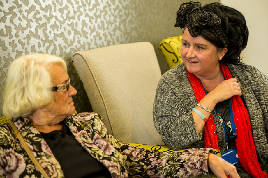 Photo of two people sat talking