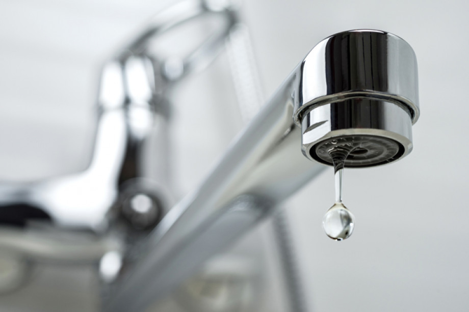 Close up photo of water dripping from a tap