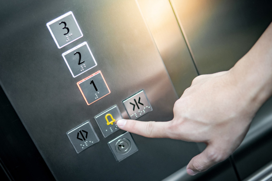Photo of someone pressing a button in a lift