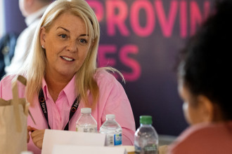 Photo of a member of staff sat at a table