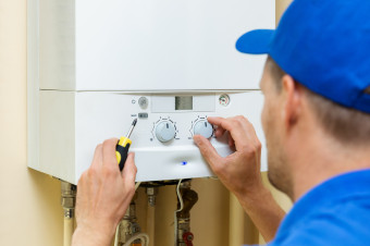 Photo showing someone working on a boiler