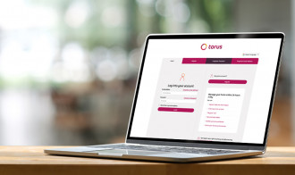 Photo of an open laptop on a table with the Torus customer portal open on the screen