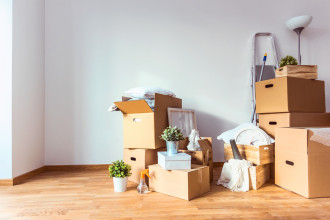 Photo of cardboard boxes piled in a room