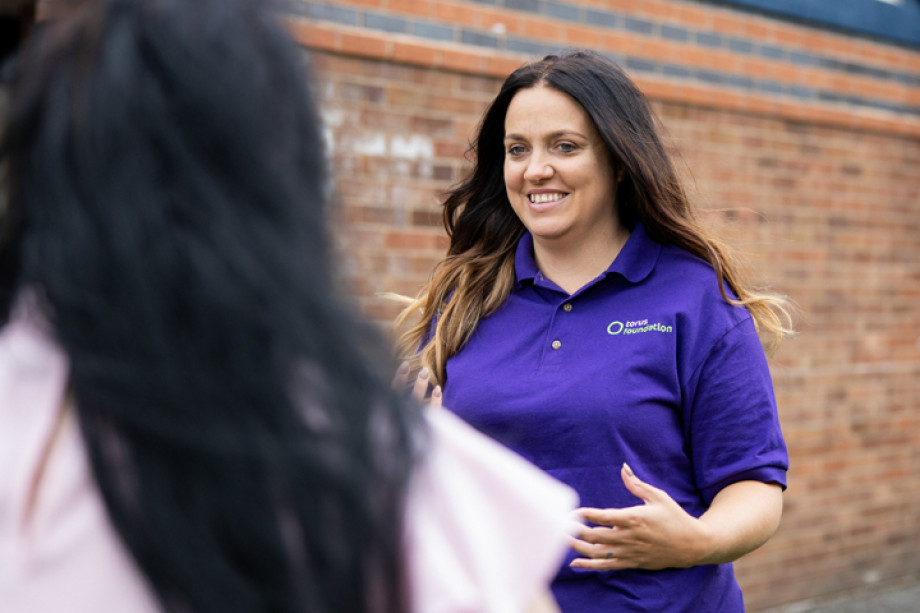 Photo of a smiling person wearing a Torus Foundation t-shirt