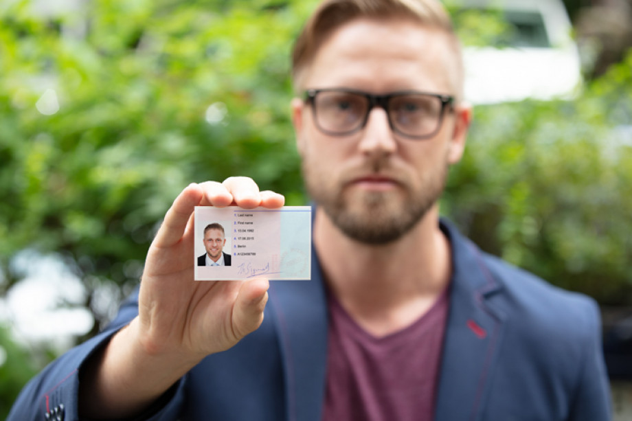 Photo of someone showing an ID badge to the camera